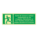 Sortie de secours à utiliser uniquement en cas d'urgence. Démolissez ce mur. Veuillez assurer votre propre sécurité en le faisant.