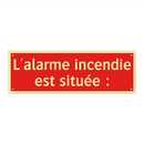 L'alarme incendie est située :