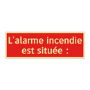 L'alarme incendie est située :