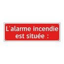 L'alarme incendie est située :