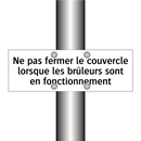 Ne pas fermer le couvercle lorsque les brûleurs sont en fonctionnement