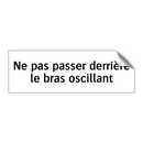 Ne pas passer derrière le bras oscillant