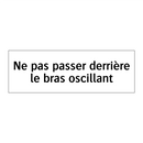 Ne pas passer derrière le bras oscillant
