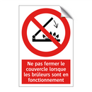 Ne pas fermer le couvercle lorsque les brûleurs sont en fonctionnement