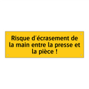Risque d'écrasement de la main entre la presse et la pièce !