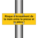 Risque d'écrasement de la main entre la presse et la pièce !