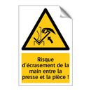 Risque d'écrasement de la main entre la presse et la pièce !
