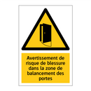 Avertissement de risque de blessure dans la zone de balancement des portes
