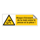 Risque d'écrasement de la main entre la presse et la pièce !